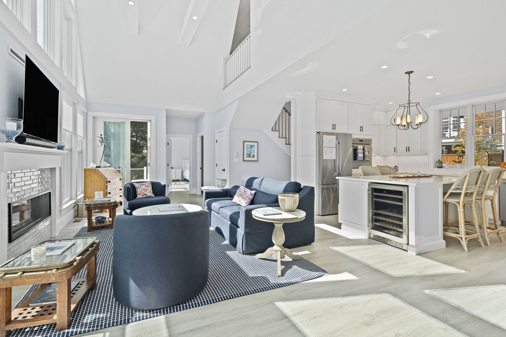 53 Border Street Scituate, MA 02066 - Photo 7 of 34 a living room with furniture a fireplace a flat screen tv and kitchen view