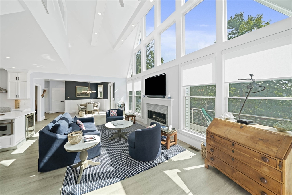 53 Border Street Scituate, MA 02066 - Photo 10 of 34 a living room with furniture a flat screen tv and a fireplace