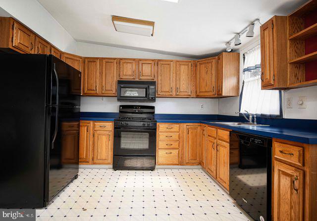 1818 Elk Road Baltimore, MD 21221 - Photo 17 of 45 a kitchen with a refrigerator and a sink