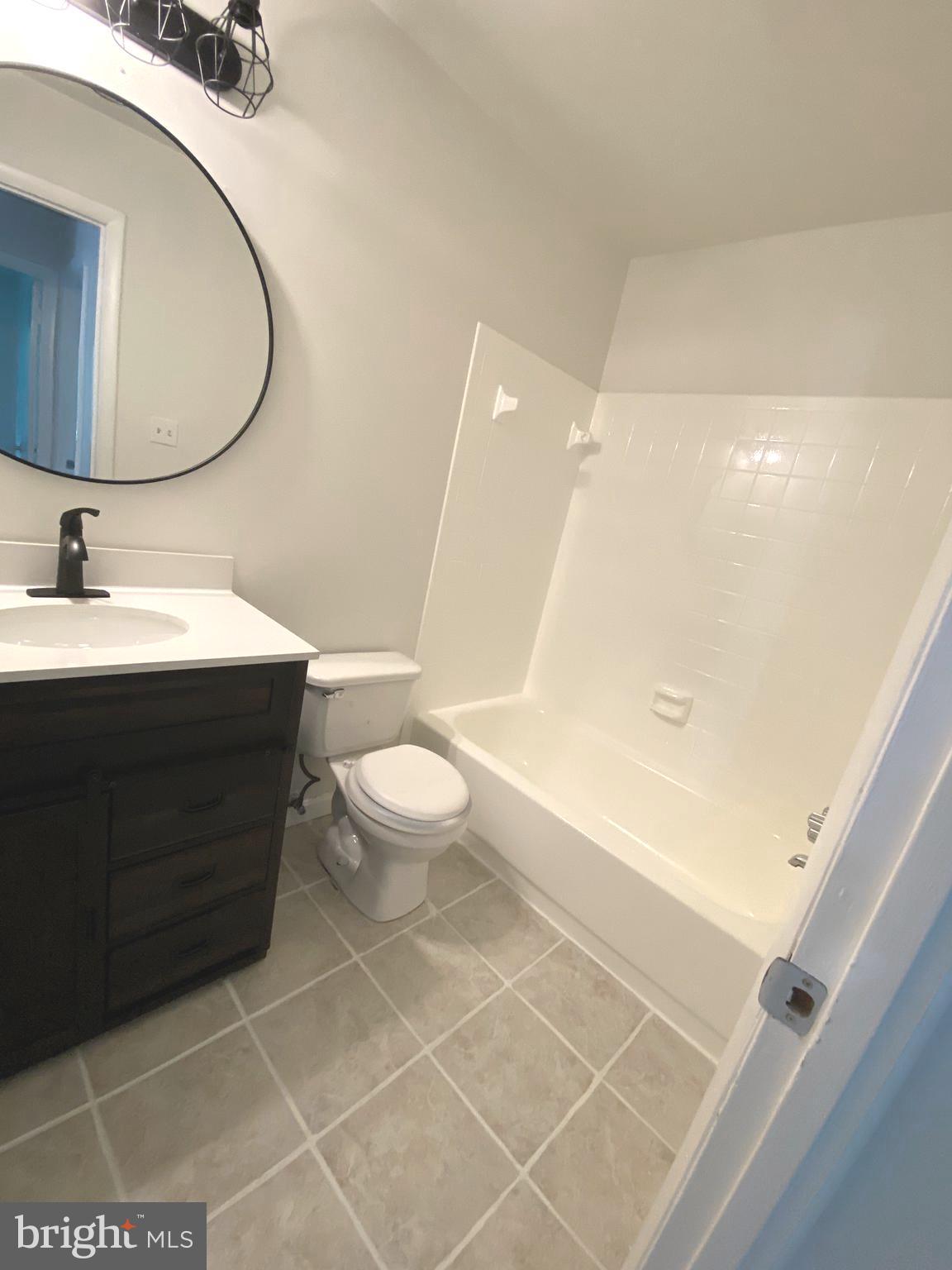 15947 Dorset Road, Unit 188 Laurel, MD 20707 - Photo 14 of 24 a bathroom with a sink a toilet and a mirror