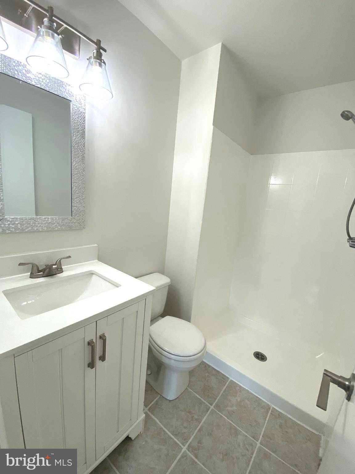 15947 Dorset Road, Unit 188 Laurel, MD 20707 - Photo 18 of 24 a bathroom with a sink toilet and shower