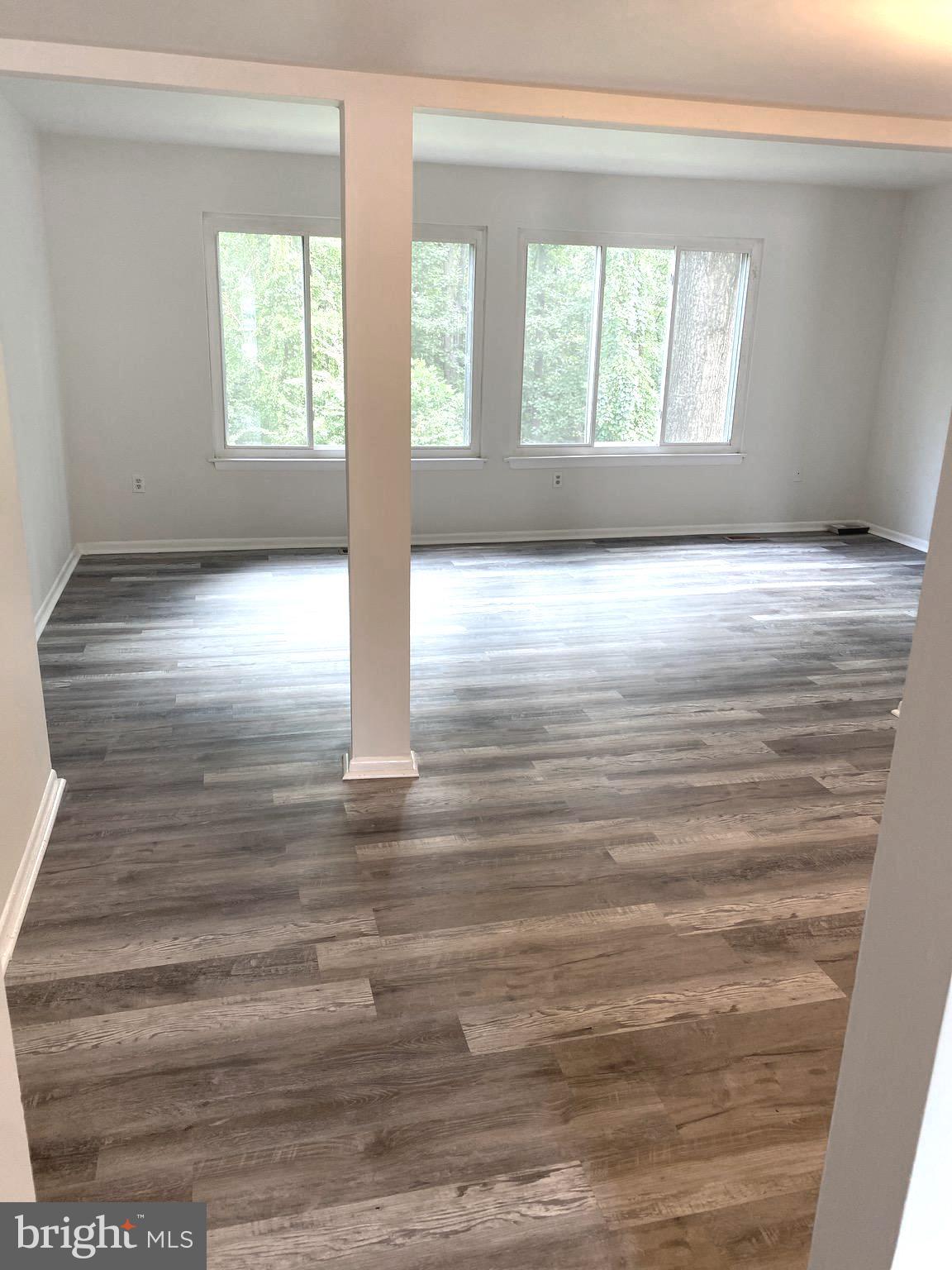 15947 Dorset Road, Unit 188 Laurel, MD 20707 - Photo 5 of 24 a view of empty room with wooden floor and fan