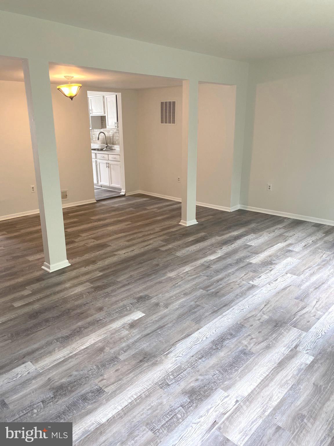 15947 Dorset Road, Unit 188 Laurel, MD 20707 - Photo 6 of 24 a view of empty room with wooden floor and fan