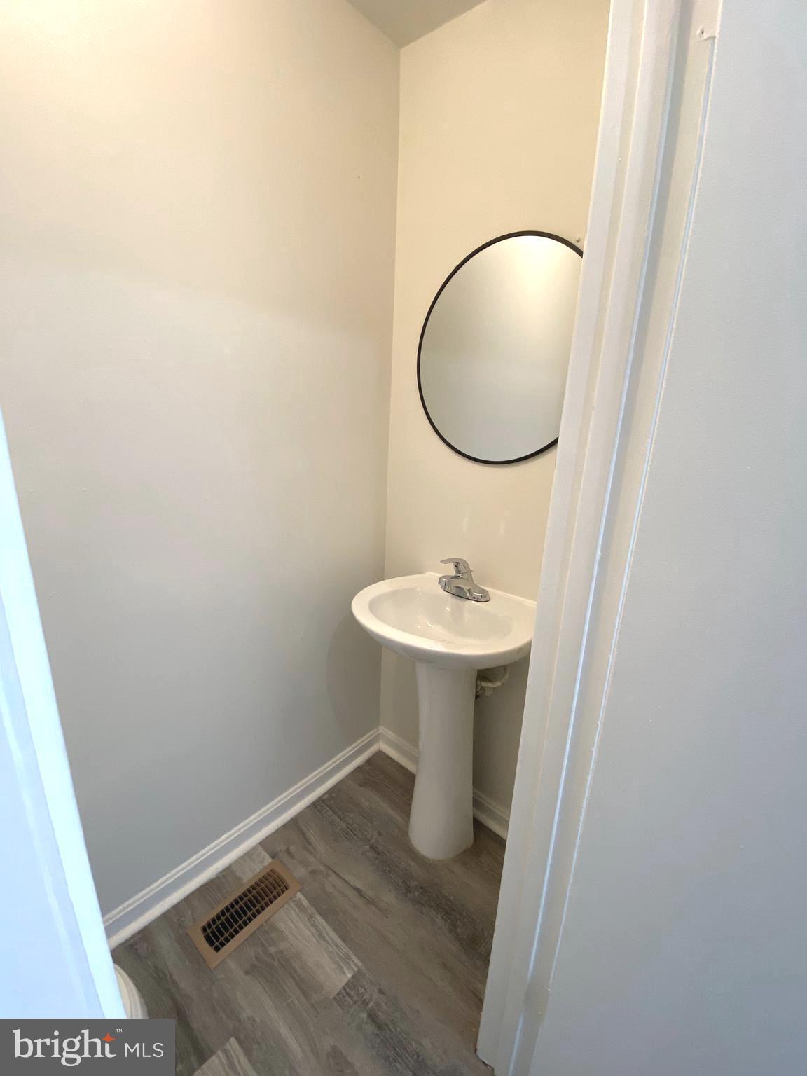 15947 Dorset Road, Unit 188 Laurel, MD 20707 - Photo 8 of 24 a bathroom with a sink toilet and mirror