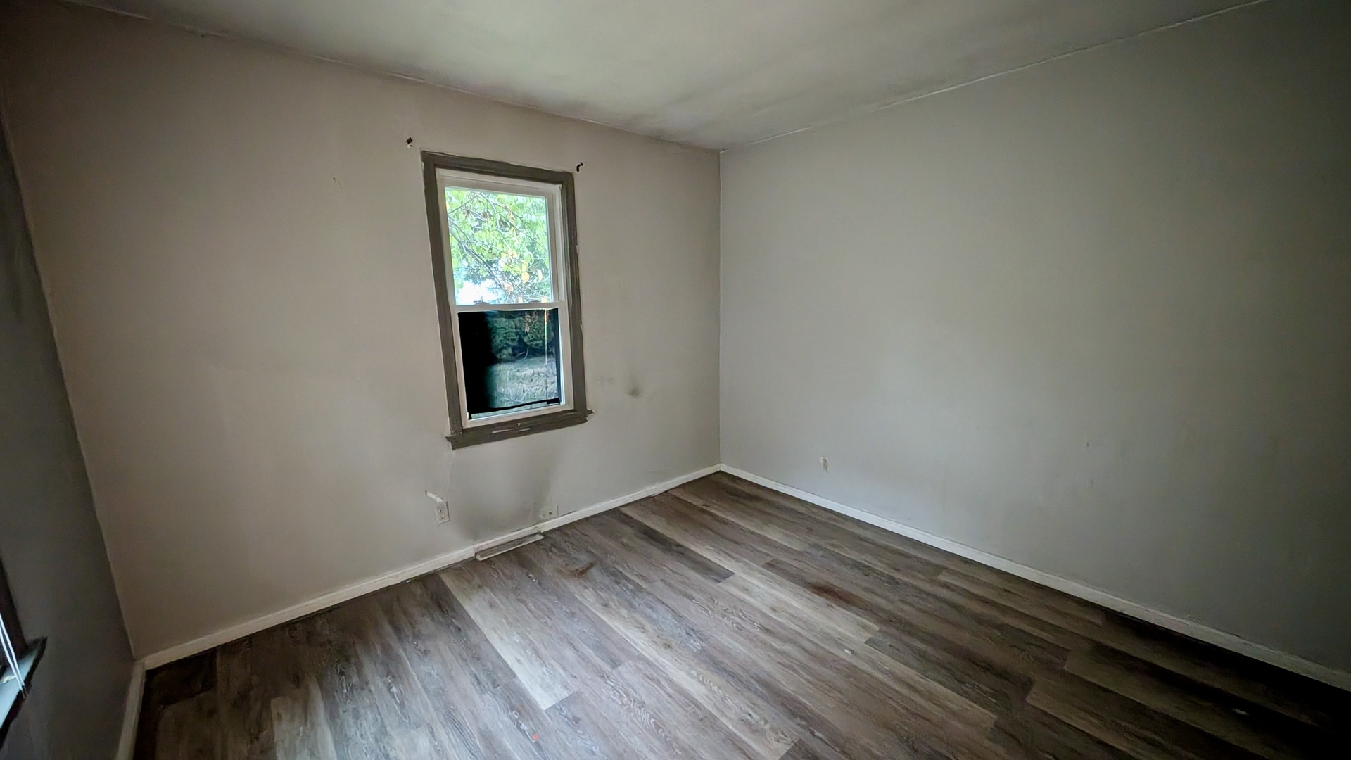 639 Wood Court Kankakee, IL 60901 - Photo 28 of 43 a view of an empty room with wooden floor and a window