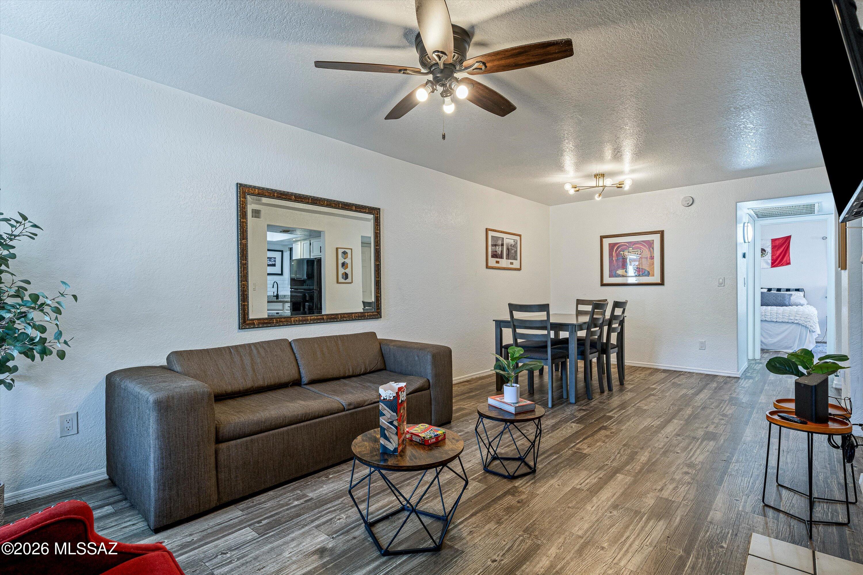 5800 North Kolb Road, Unit 1102 Tucson, AZ 85750 - Photo 3 of 36 a living room with furniture and wooden floor