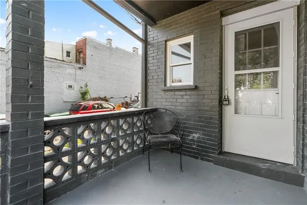 a front view of a house with outdoor seating and stairs