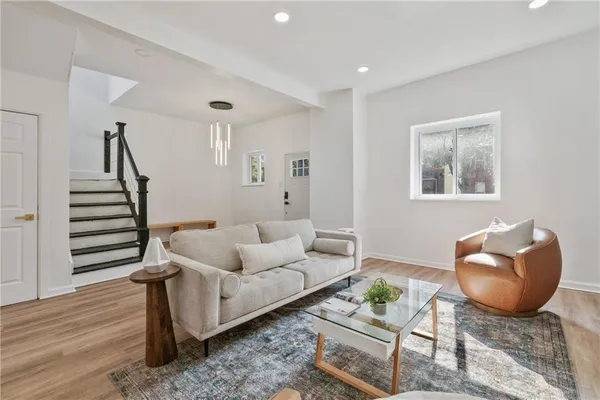 a living room with furniture and wooden floor