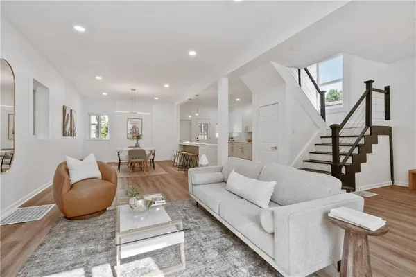 a living room with furniture and a wooden floor