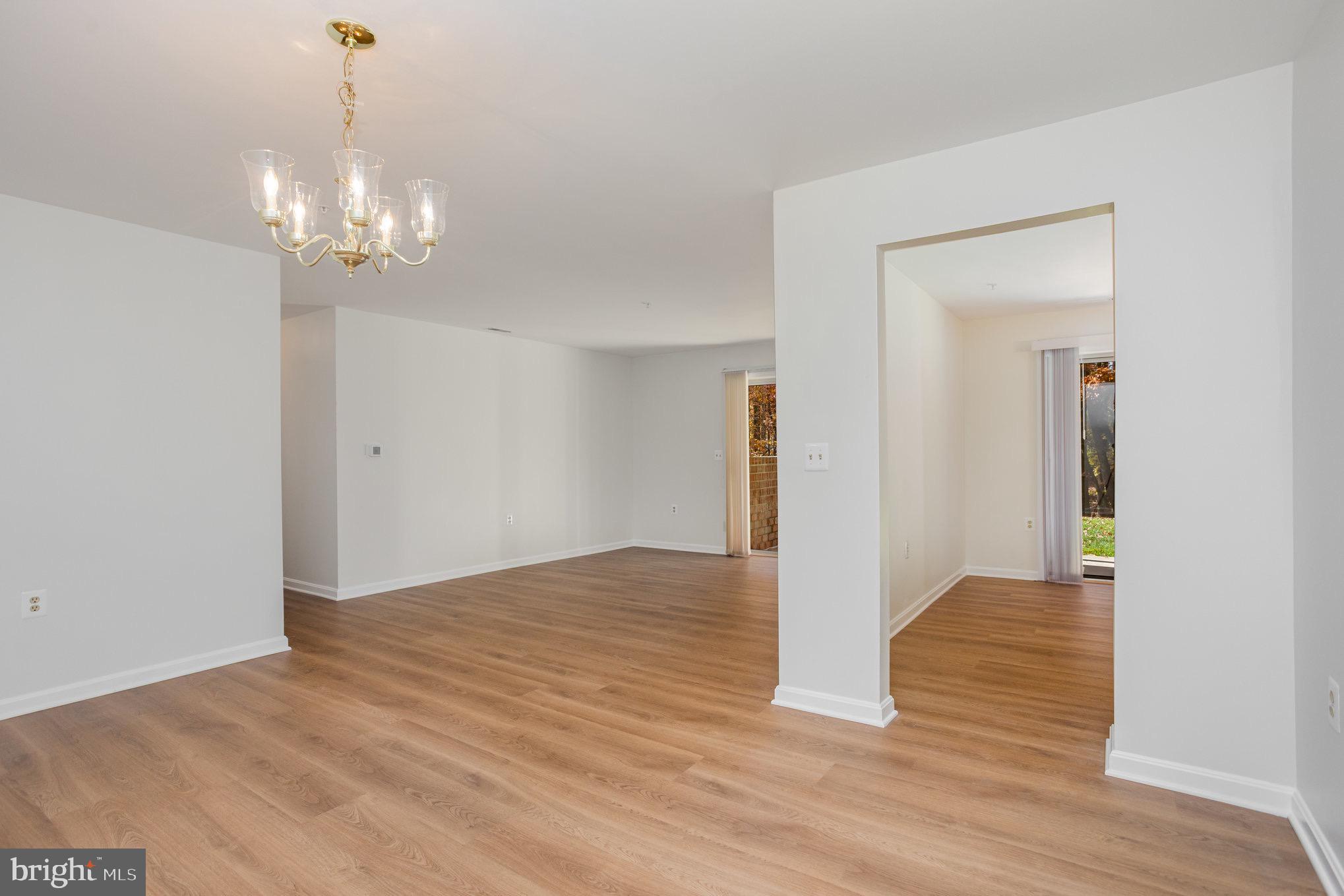 3901 Darleigh Road, Unit C Nottingham, MD 21236 - Photo 7 of 23 a view of an empty room with wooden floor and chandelier