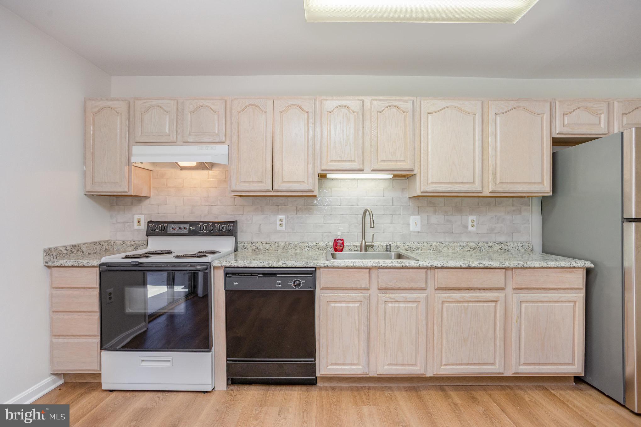 3901 Darleigh Road, Unit C Nottingham, MD 21236 - Photo 10 of 23 a kitchen with granite countertop white cabinets and stainless steel appliances