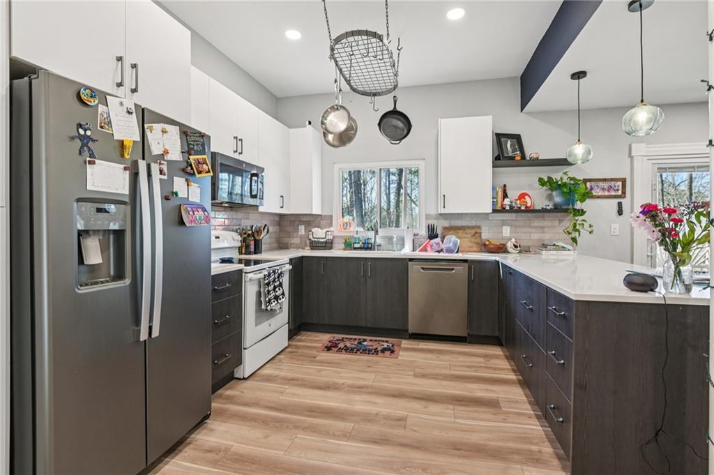 9485 Martin Road Roswell, GA 30076 - Photo 21 of 33 a kitchen with stainless steel appliances a refrigerator a sink and a stove