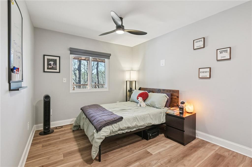 9485 Martin Road Roswell, GA 30076 - Photo 22 of 33 a bedroom with a bed and wooden floor