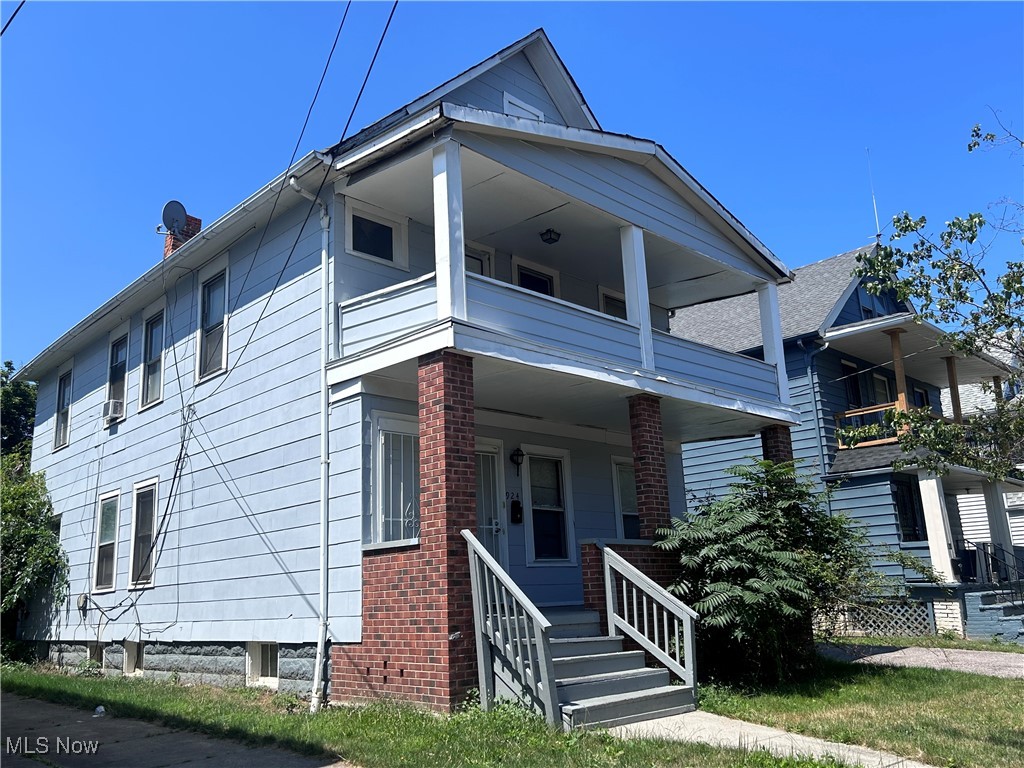 924 Stevenson Road Cleveland, OH 44110 - Photo 2 of 3 View of front of home with a balcony, a porch, and brick siding