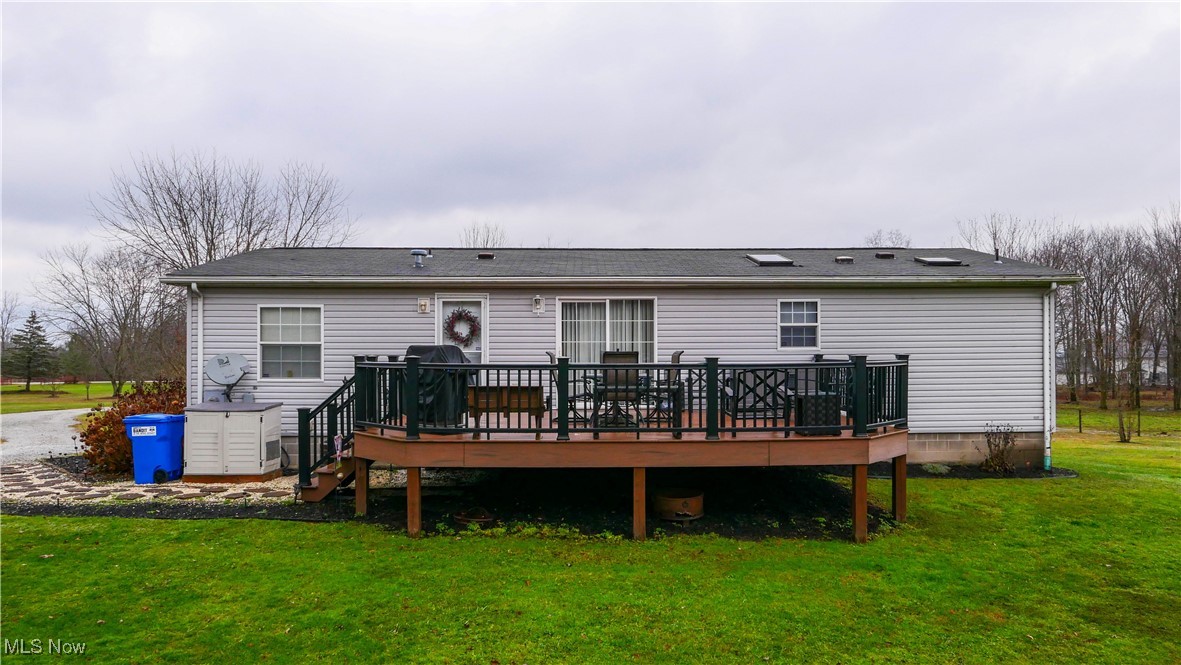 17296 Old State Road Middlefield, OH 44062 - Photo 33 of 44 Back of property featuring a yard and a wooden deck