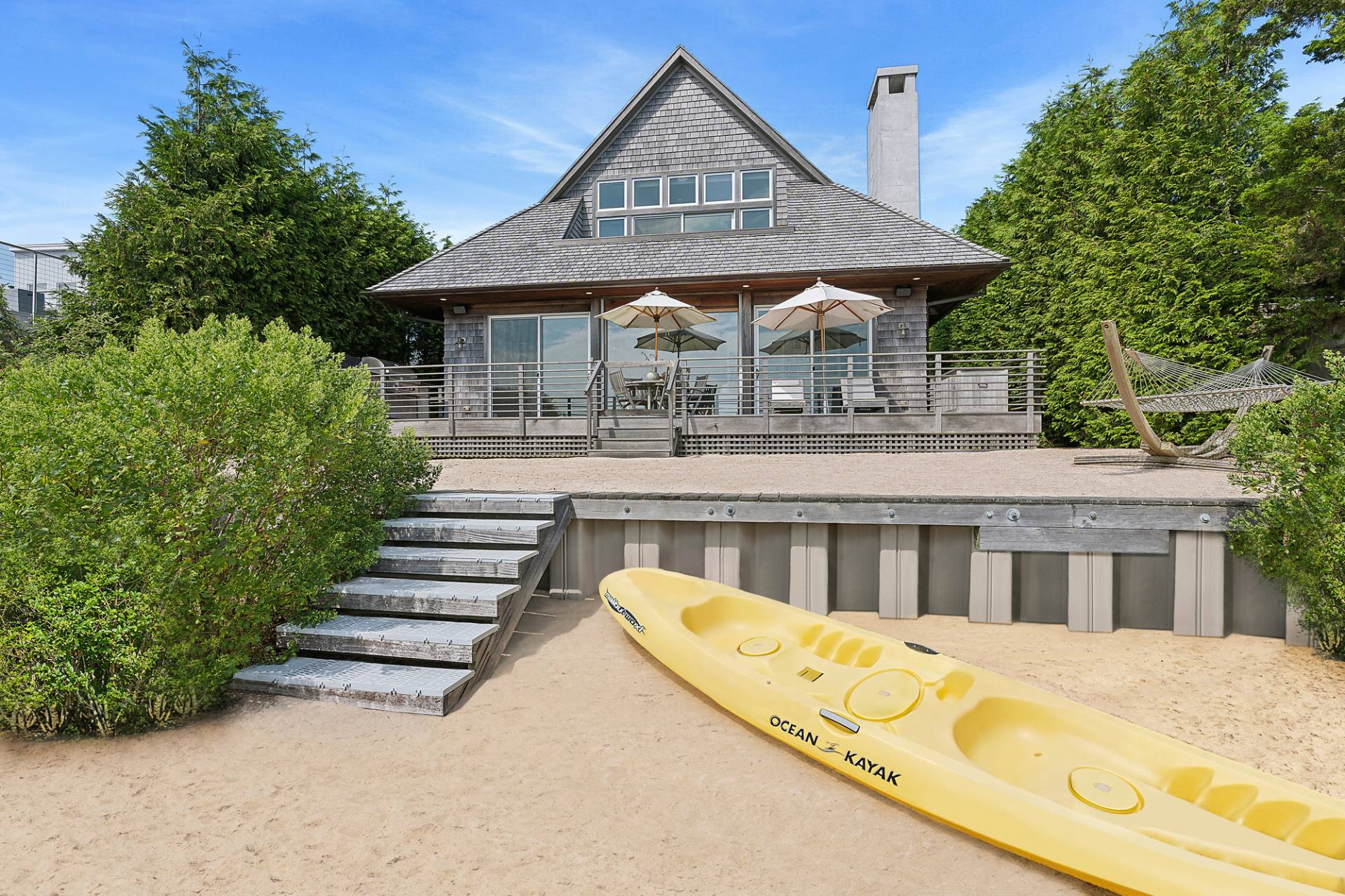 210 Towd Point Road Southampton, NY 11968 - Photo 2 of 21 a front view of a house with swimming pool