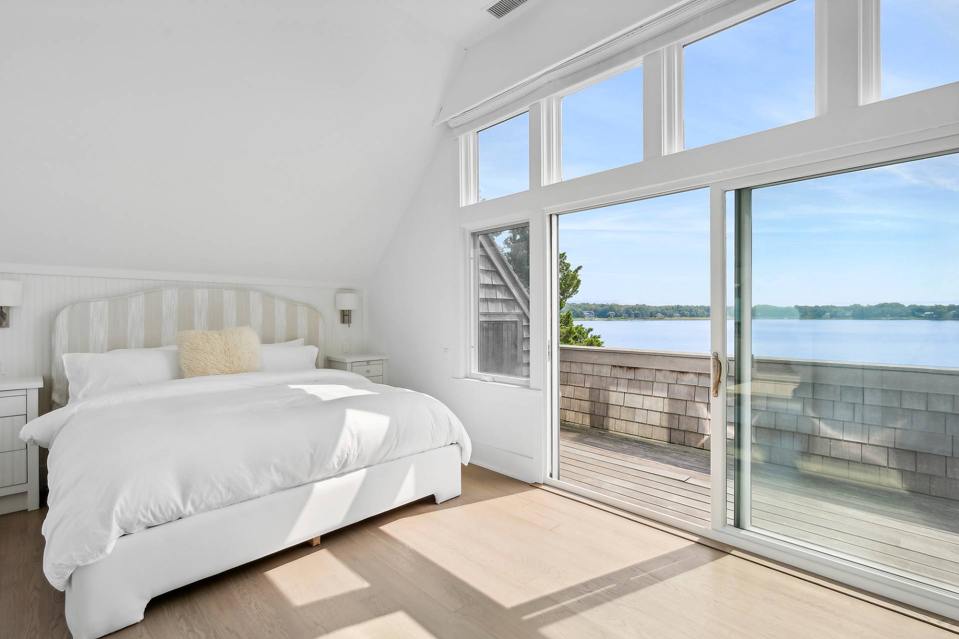 210 Towd Point Road Southampton, NY 11968 - Photo 8 of 21 a bedroom with a bed and a large window