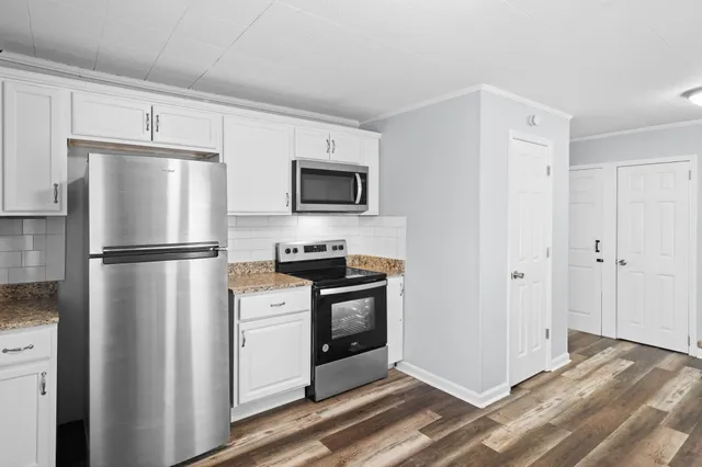 a kitchen with a refrigerator stove and microwave