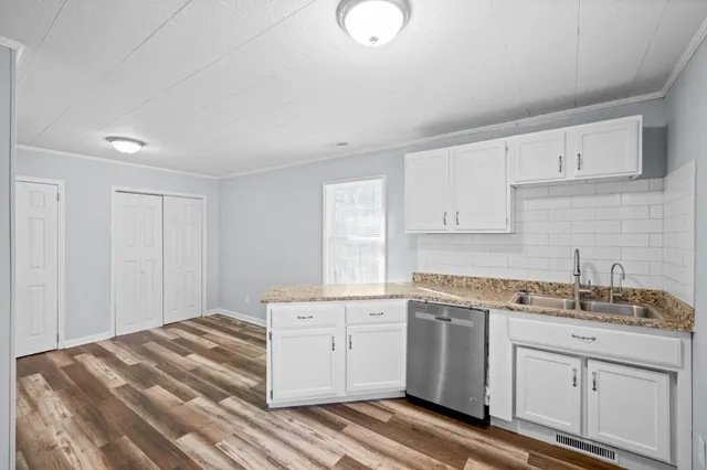 a kitchen with a sink stove and cabinets