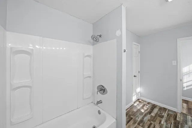 a bathroom with a bathtub and a shower