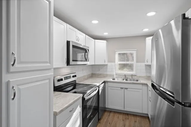 a kitchen with a sink cabinets and window