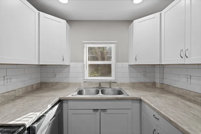 a kitchen with a refrigerator and a sink