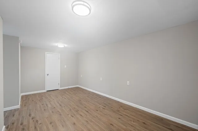 a bathroom with a toilet a sink a mirror and vanity