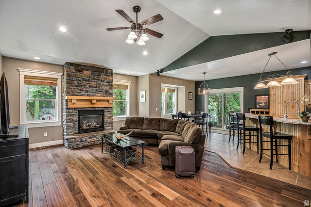 288 525 South Providence, UT 84332 - Photo 2 of 71 Stone-clad fireplace with wood mantle, vaulted ceilings, recessed lighting, and wood-finish flooring
