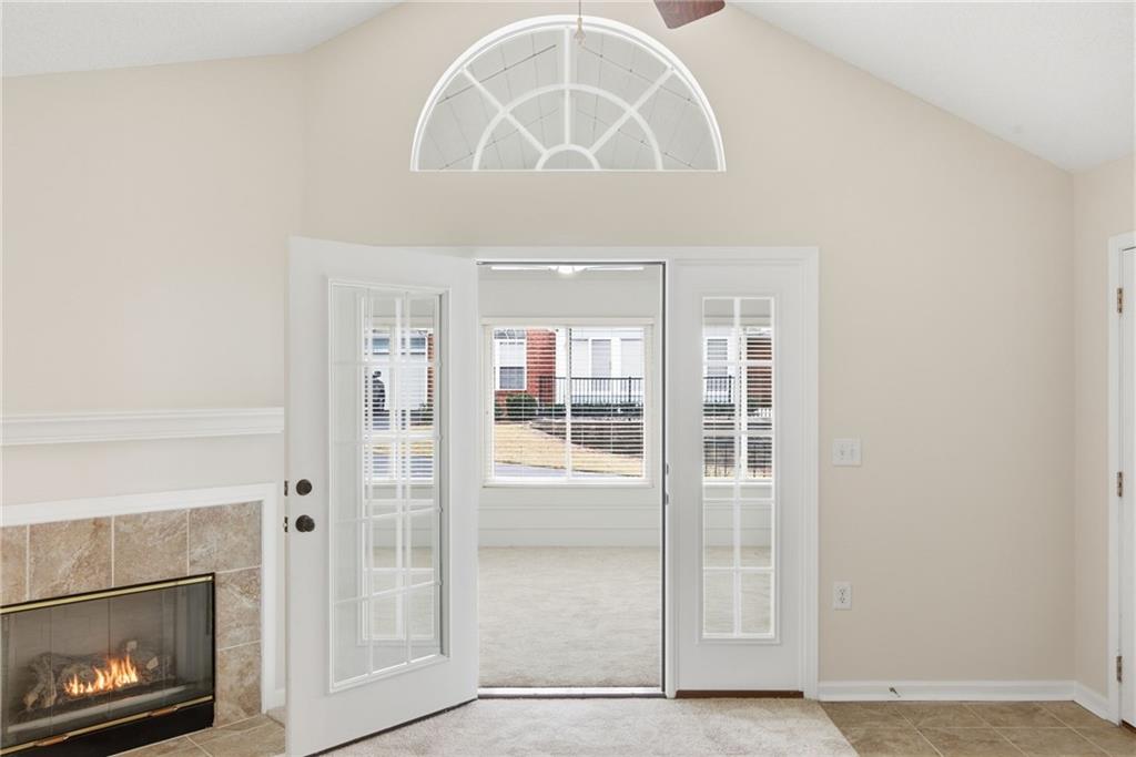 34102 Harvest Ridge Lane, Unit 34 Alpharetta, GA 30022 - Photo 15 of 31 an empty room with wooden floor a fireplace and a large window