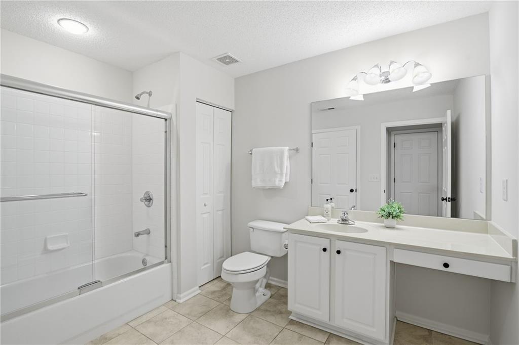 34102 Harvest Ridge Lane, Unit 34 Alpharetta, GA 30022 - Photo 26 of 31 a bathroom with a bathtub shower sink mirror and toilet
