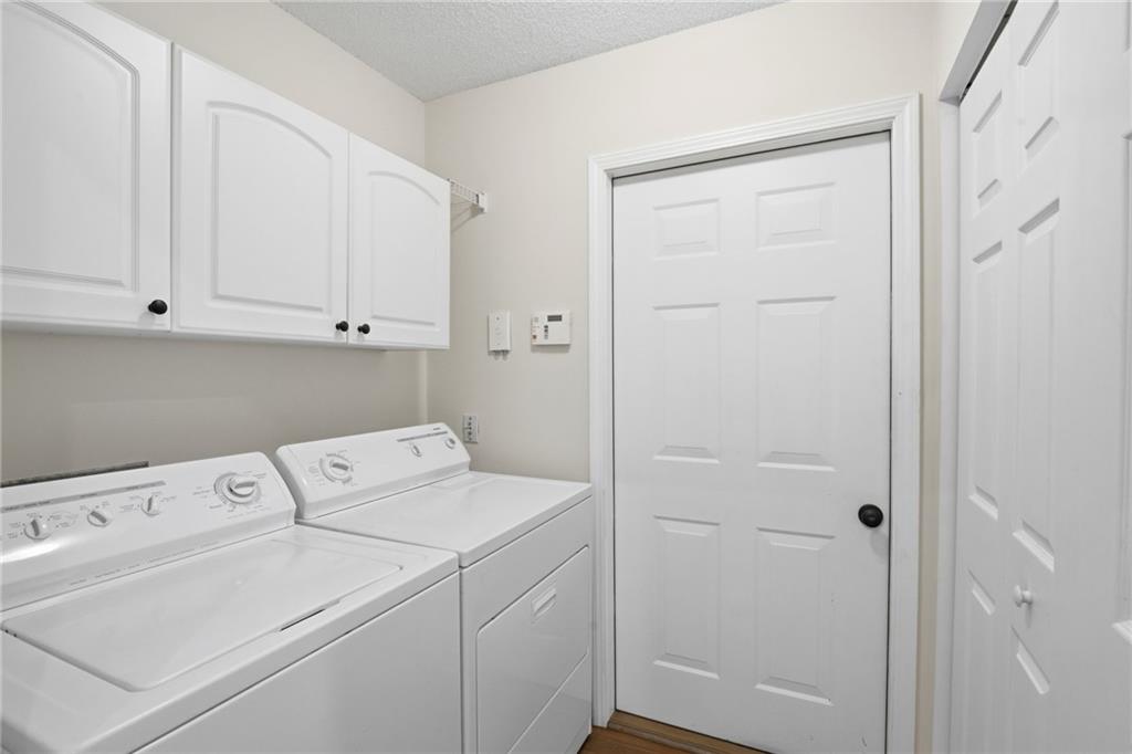 34102 Harvest Ridge Lane, Unit 34 Alpharetta, GA 30022 - Photo 28 of 31 a utility room with dryer and washer