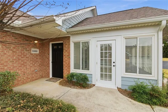 a view of a big house with a big yard and large tree