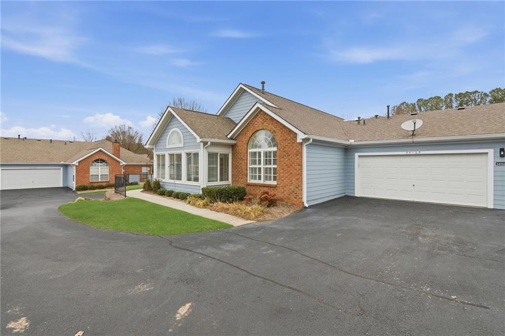 34102 Harvest Ridge Lane, Unit 34 Alpharetta, GA 30022 - Photo 30 of 31 a view of a big house with a big yard and large tree