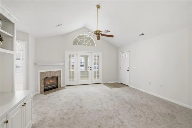 a view of empty room with fireplace