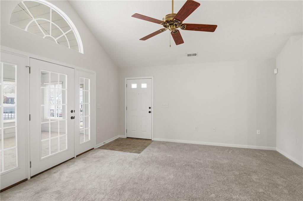 34102 Harvest Ridge Lane, Unit 34 Alpharetta, GA 30022 - Photo 5 of 31 an empty room with a ceiling fan and window