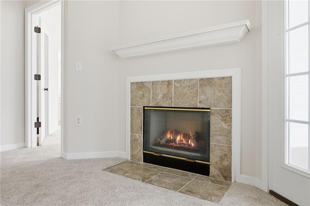 34102 Harvest Ridge Lane, Unit 34 Alpharetta, GA 30022 - Photo 6 of 31 a living room with a fireplace