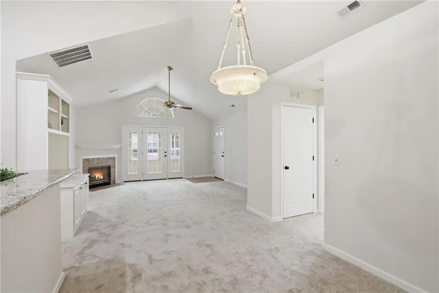 a view of a kitchen with a sink and chandelier
