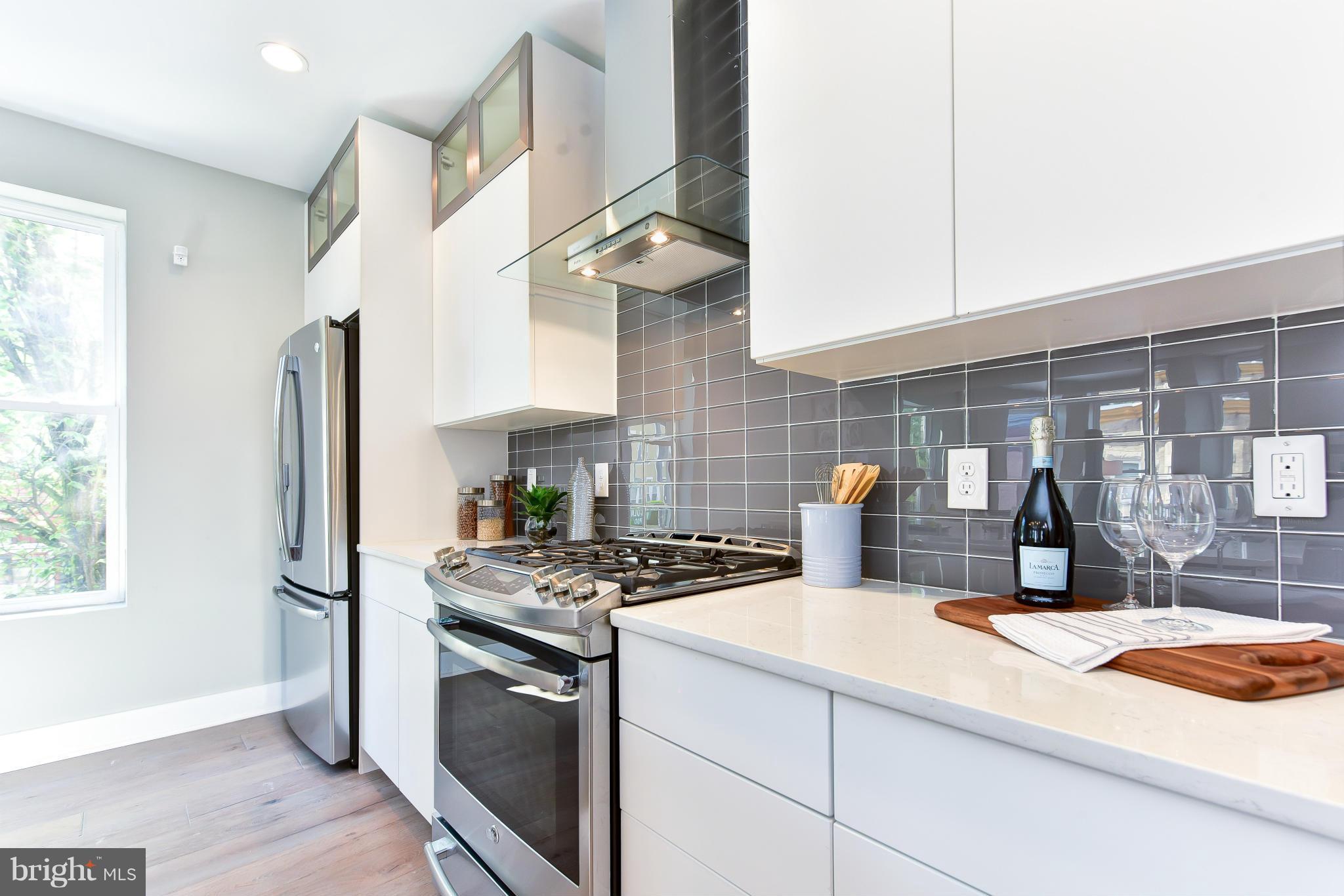37 Todd Place Northeast, Unit 2 Washington, DC 20002 - Photo 11 of 21 a kitchen with stainless steel appliances granite countertop a sink stove and refrigerator