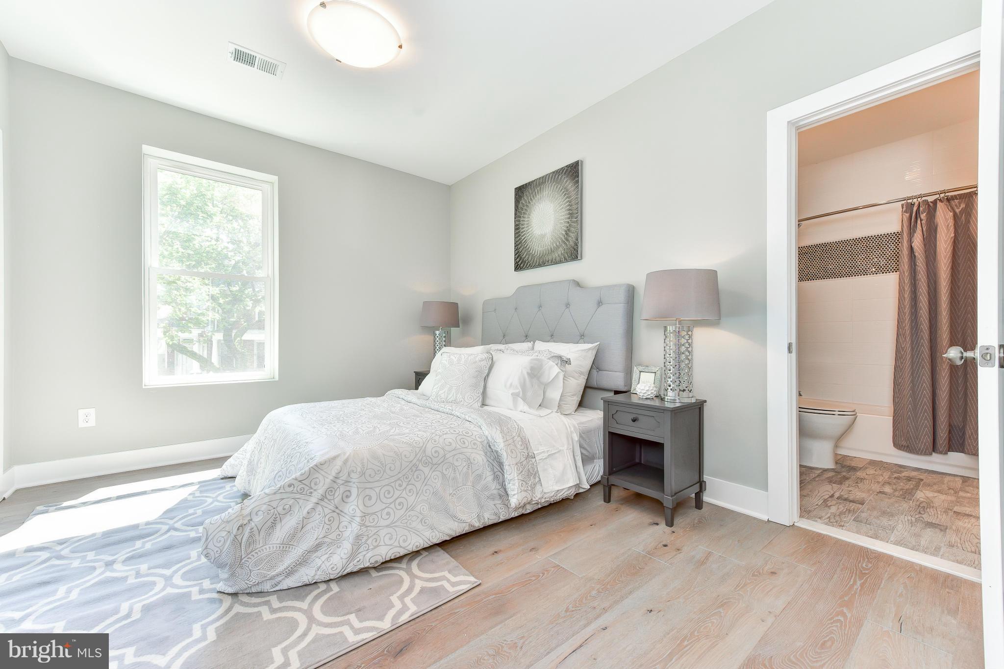 37 Todd Place Northeast, Unit 2 Washington, DC 20002 - Photo 14 of 21 a bedroom with a bed and a large mirror