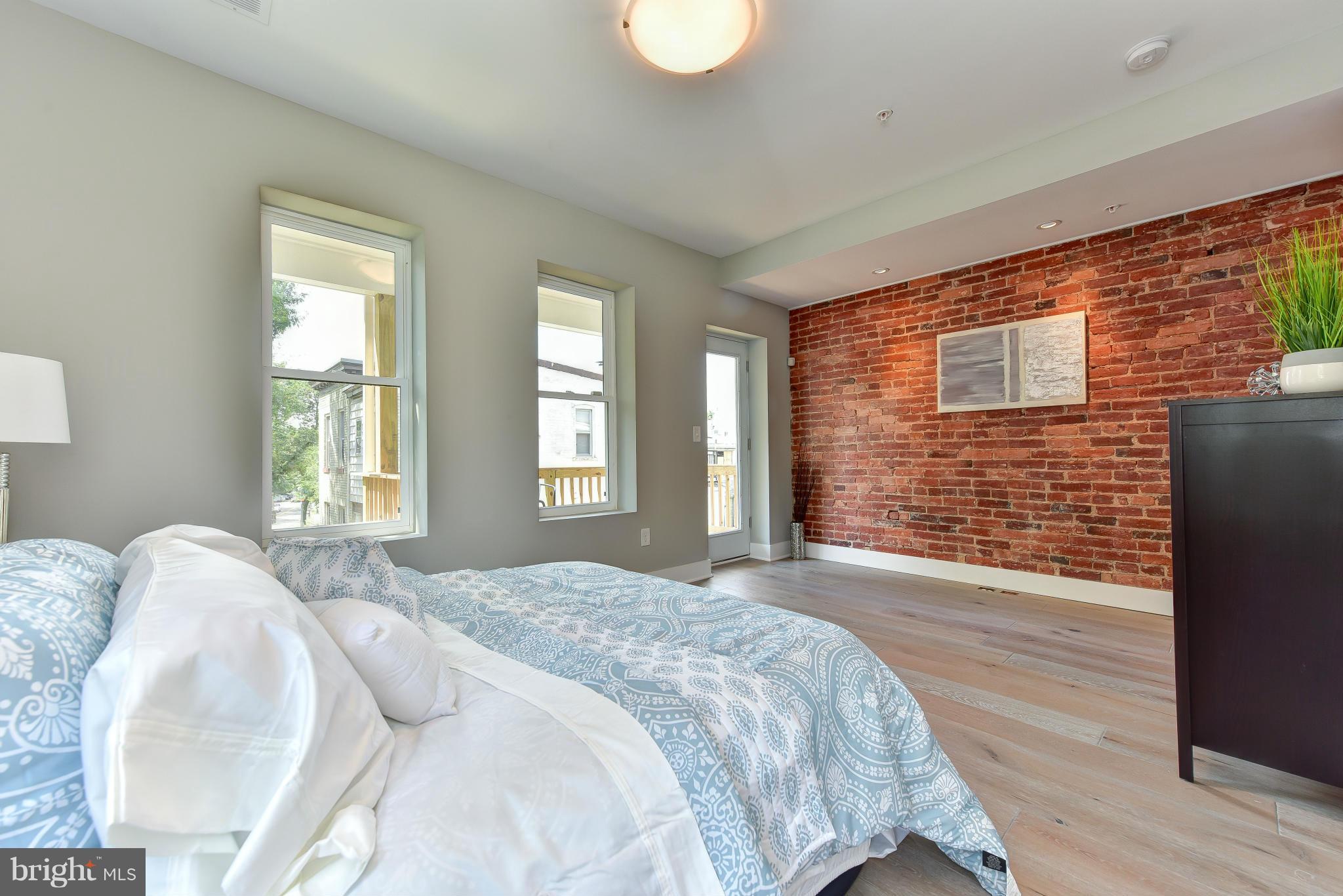 37 Todd Place Northeast, Unit 2 Washington, DC 20002 - Photo 18 of 21 a spacious bedroom with a bed and a dresser next to a window