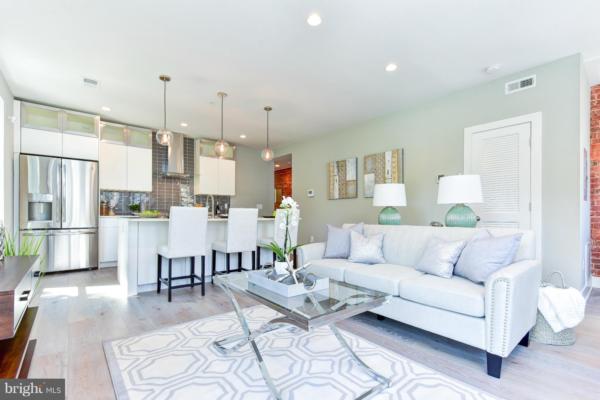 37 Todd Place Northeast, Unit 2 Washington, DC 20002 - Photo 6 of 21 a living room with furniture kitchen view and a wooden floor
