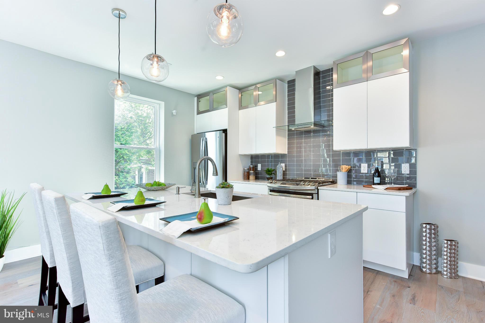 37 Todd Place Northeast, Unit 2 Washington, DC 20002 - Photo 8 of 21 a kitchen with a sink a stove and chairs