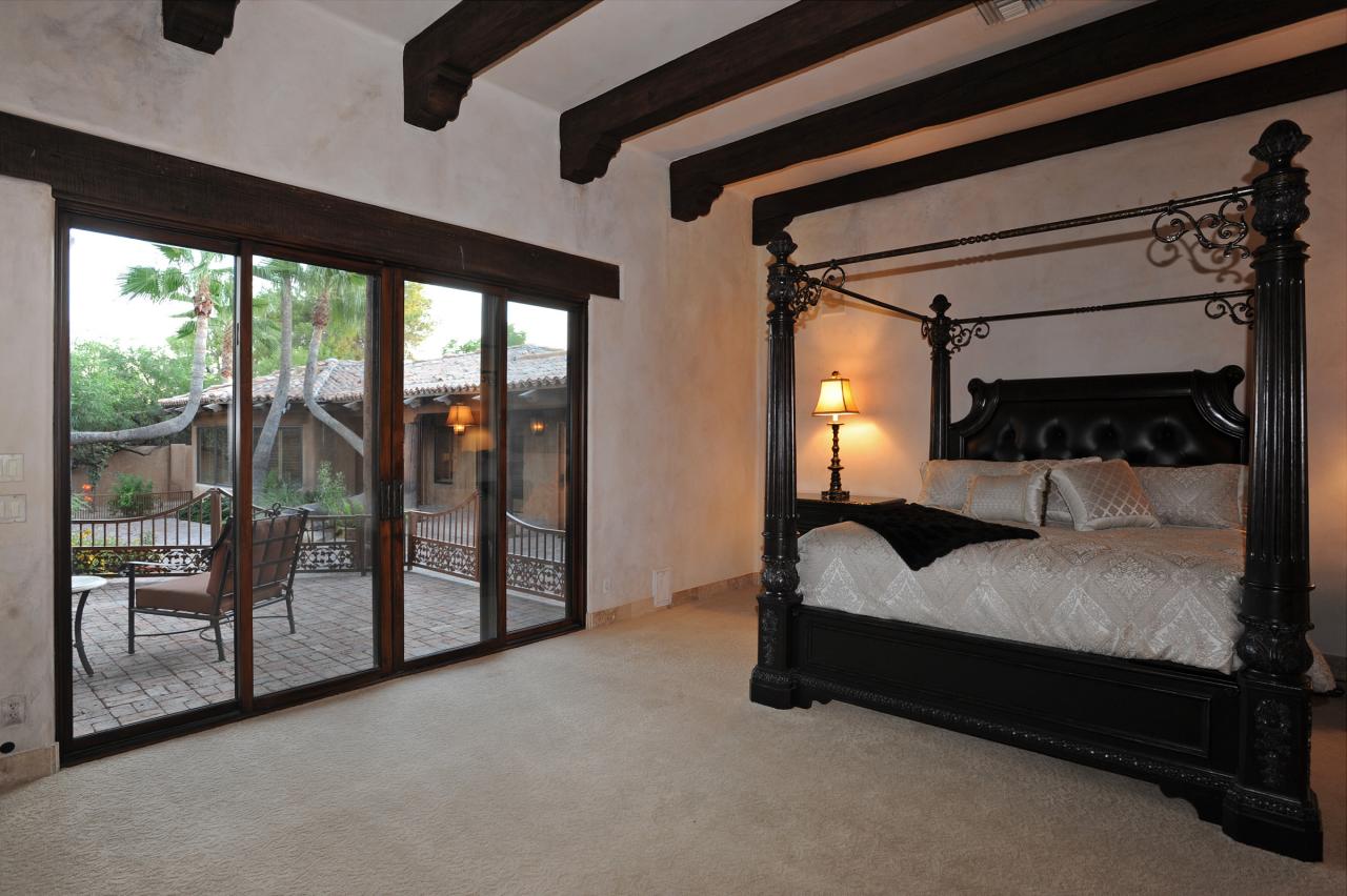 4811 East Pebble Ridge Road Paradise Valley, AZ 85253 - Photo 11 of 20 a spacious bedroom with a bed and large window