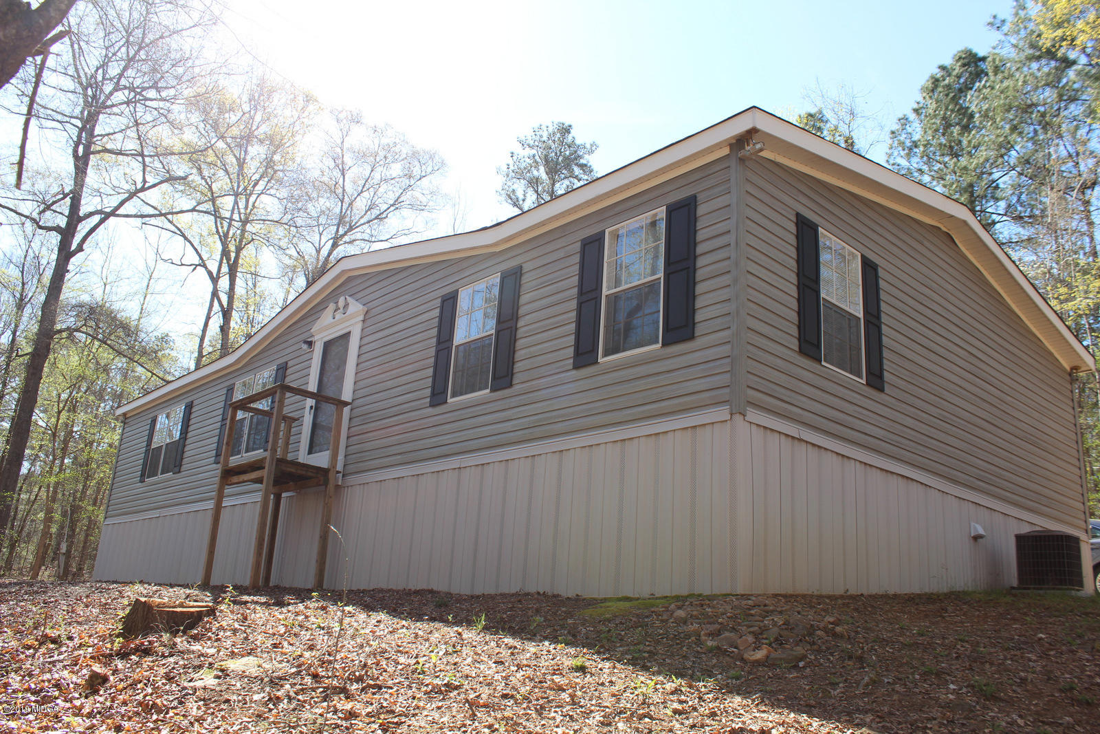 10094 Zebulon Road Forsyth, GA 31029 - Photo 2 of 20 a front view of a house with a yard