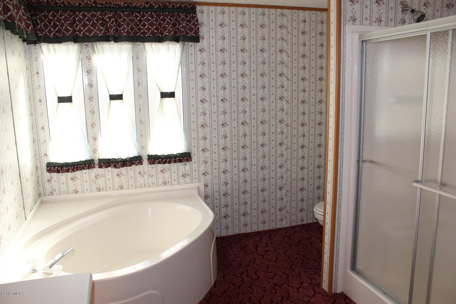 10094 Zebulon Road Forsyth, GA 31029 - Photo 13 of 20 a bathroom with a bathtub and a shower