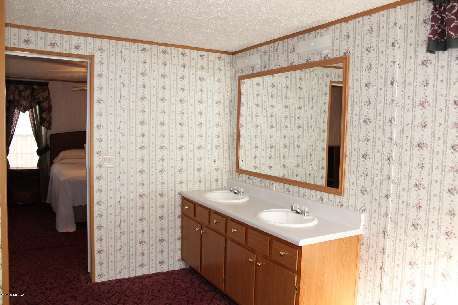 10094 Zebulon Road Forsyth, GA 31029 - Photo 14 of 20 a bathroom with a sink a mirror and a shower