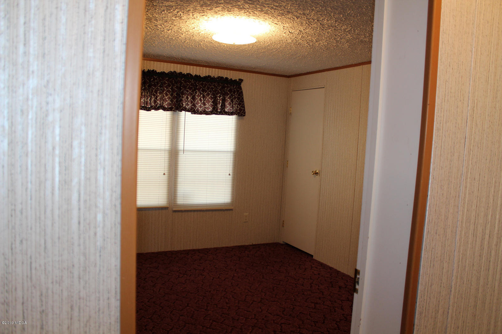 10094 Zebulon Road Forsyth, GA 31029 - Photo 16 of 20 a view of an empty room with a window