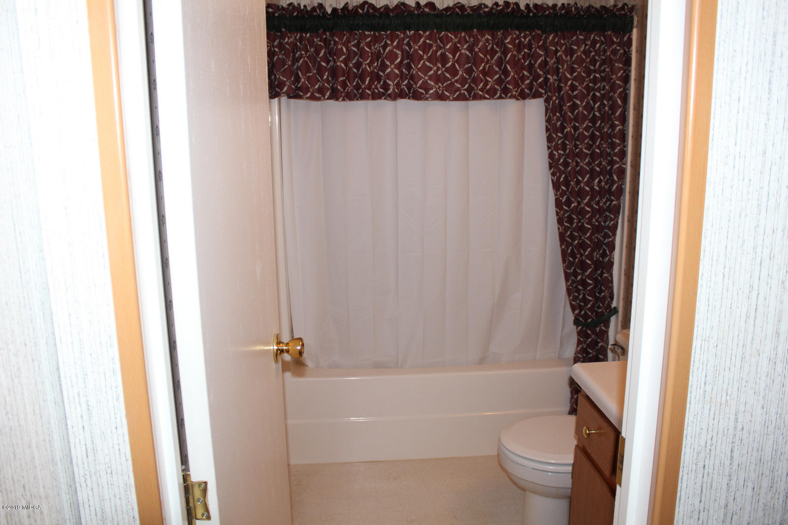 10094 Zebulon Road Forsyth, GA 31029 - Photo 17 of 20 a bathroom with a toilet and a shower curtain