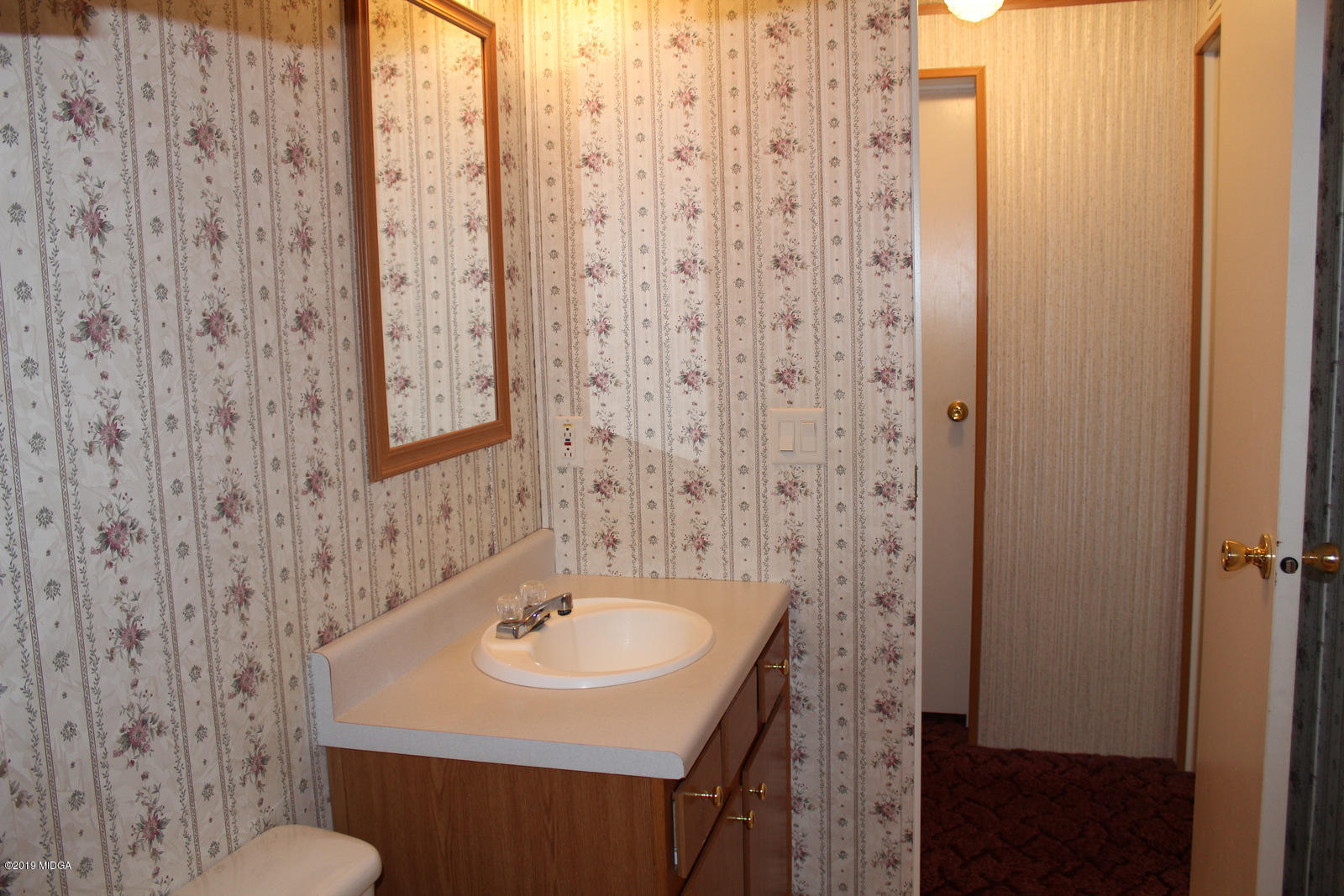 10094 Zebulon Road Forsyth, GA 31029 - Photo 18 of 20 a bathroom with a sink and a toilet