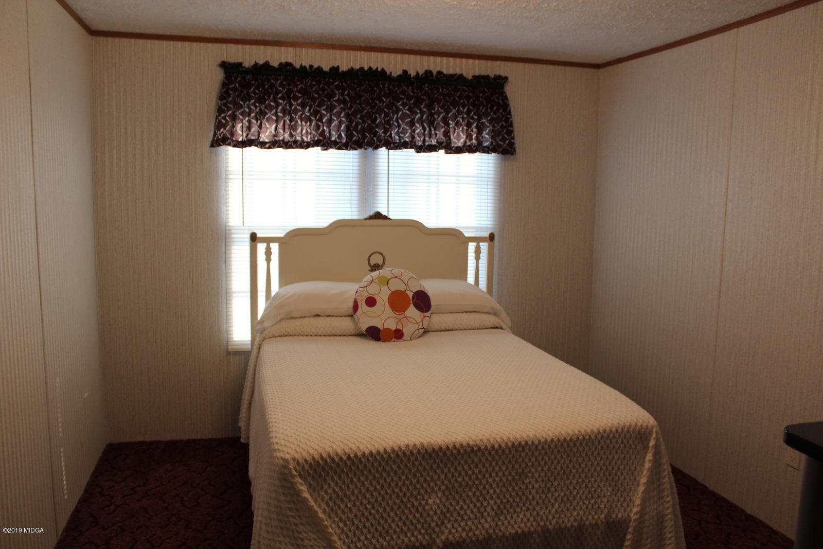 10094 Zebulon Road Forsyth, GA 31029 - Photo 19 of 20 a bedroom with a bed and window